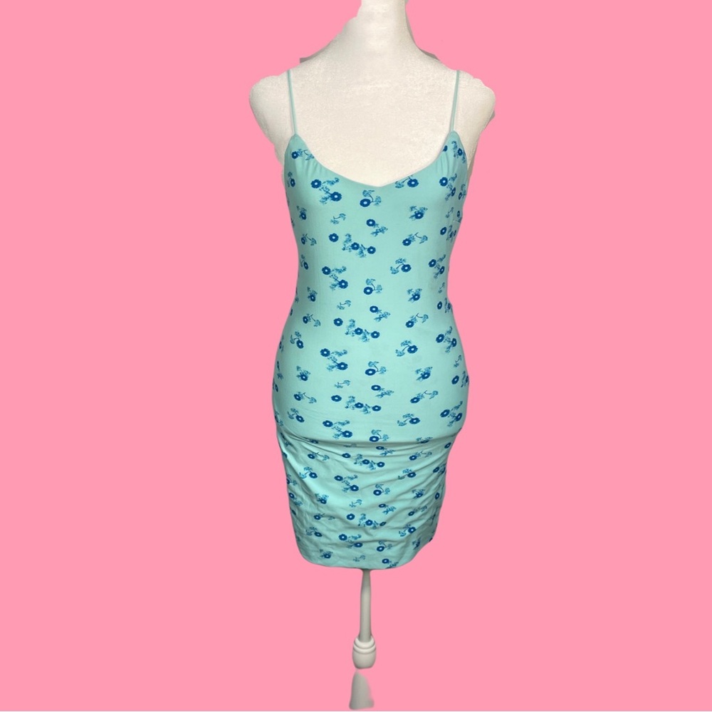 Elegant baby blue skin tight dress with dark blue flower detailing.